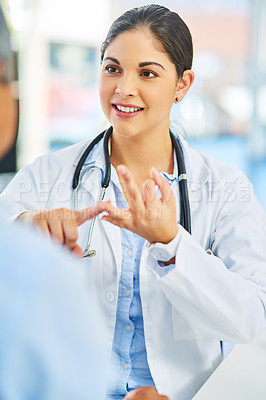 Buy stock photo Shot of a young female doctor giving a patient advice during a consultation