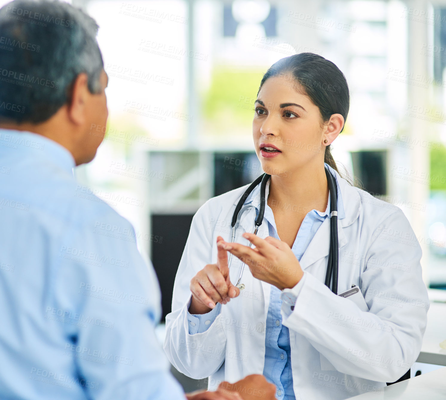 Buy stock photo Shot of a young female doctor giving a patient advice during a consultation