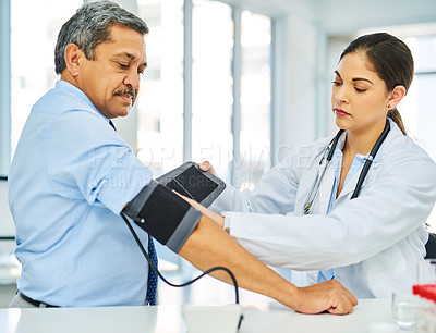 Buy stock photo Doctor, man and patient with test, blood pressure and consultation with healthcare, office and checkup. Female person, senior male and medical professional with equipment, hypertension and wellness