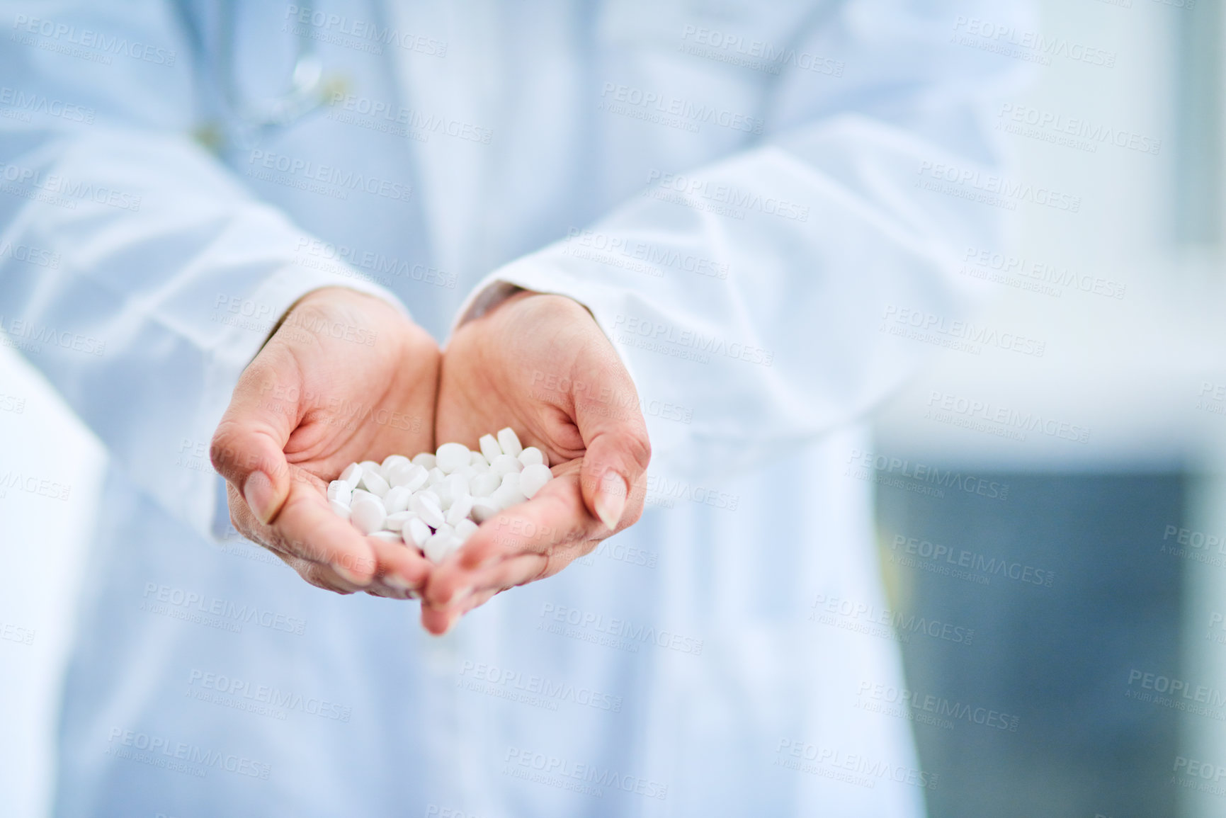 Buy stock photo Closeup shot of an unidentifiable doctor holding a variety of pills in her hands