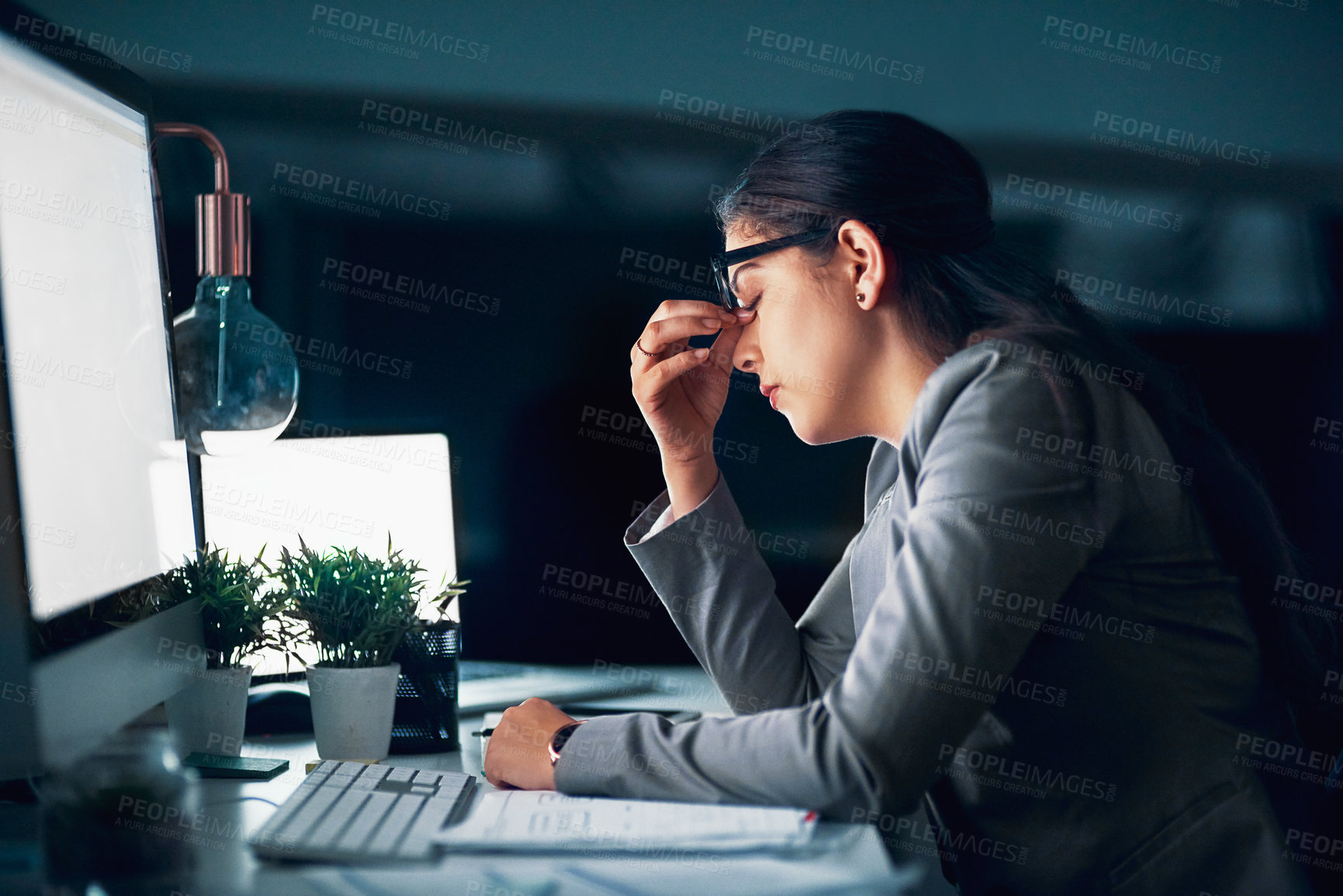 Buy stock photo Shot of a young businesswoman experiencing a headache in the office