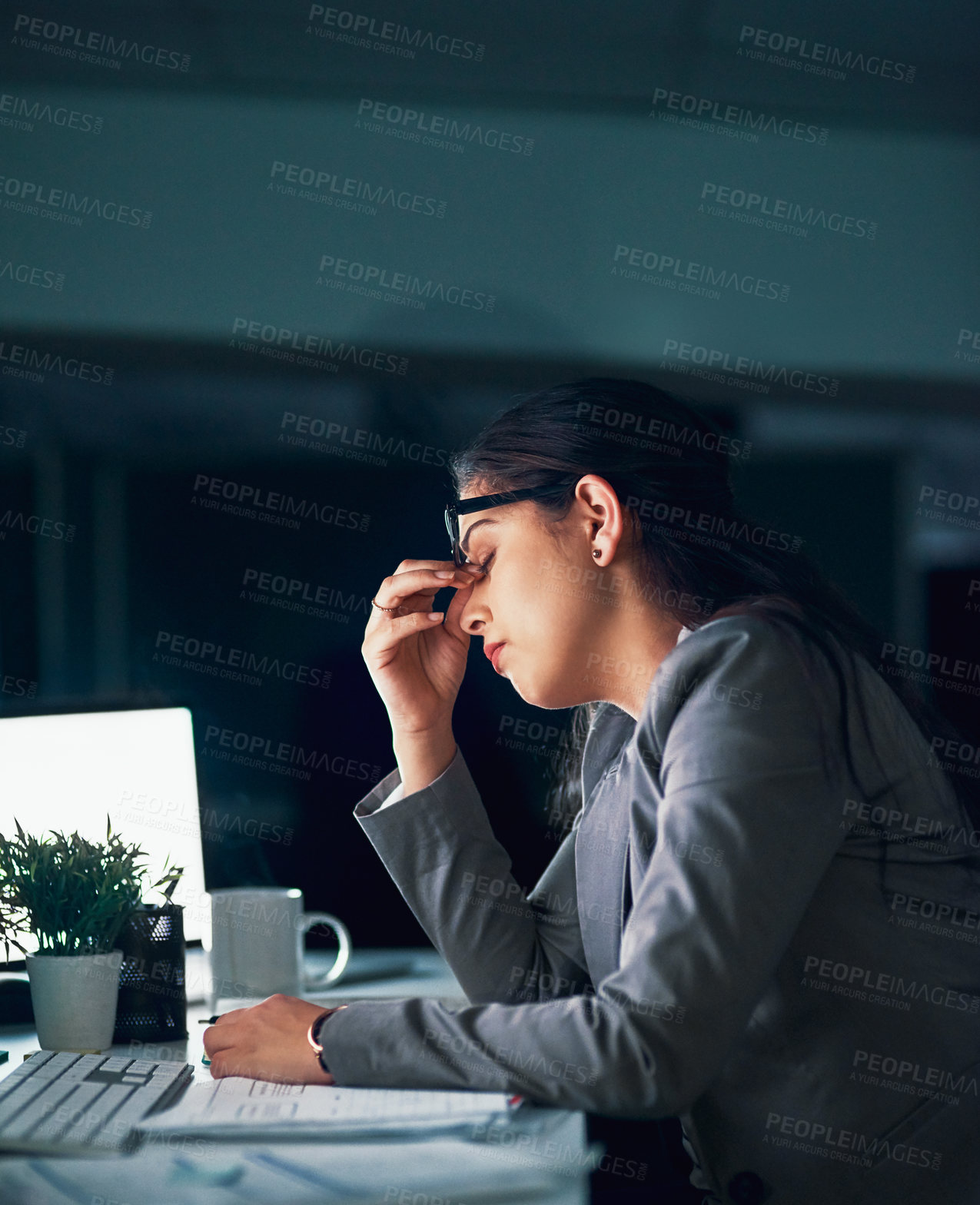 Buy stock photo Shot of a young businesswoman experiencing a headache in the office