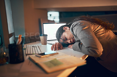 Buy stock photo Shot of a young businesswoman working late in the office