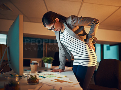 Buy stock photo Shot of a young businesswoman experiencing body discomfort in the office