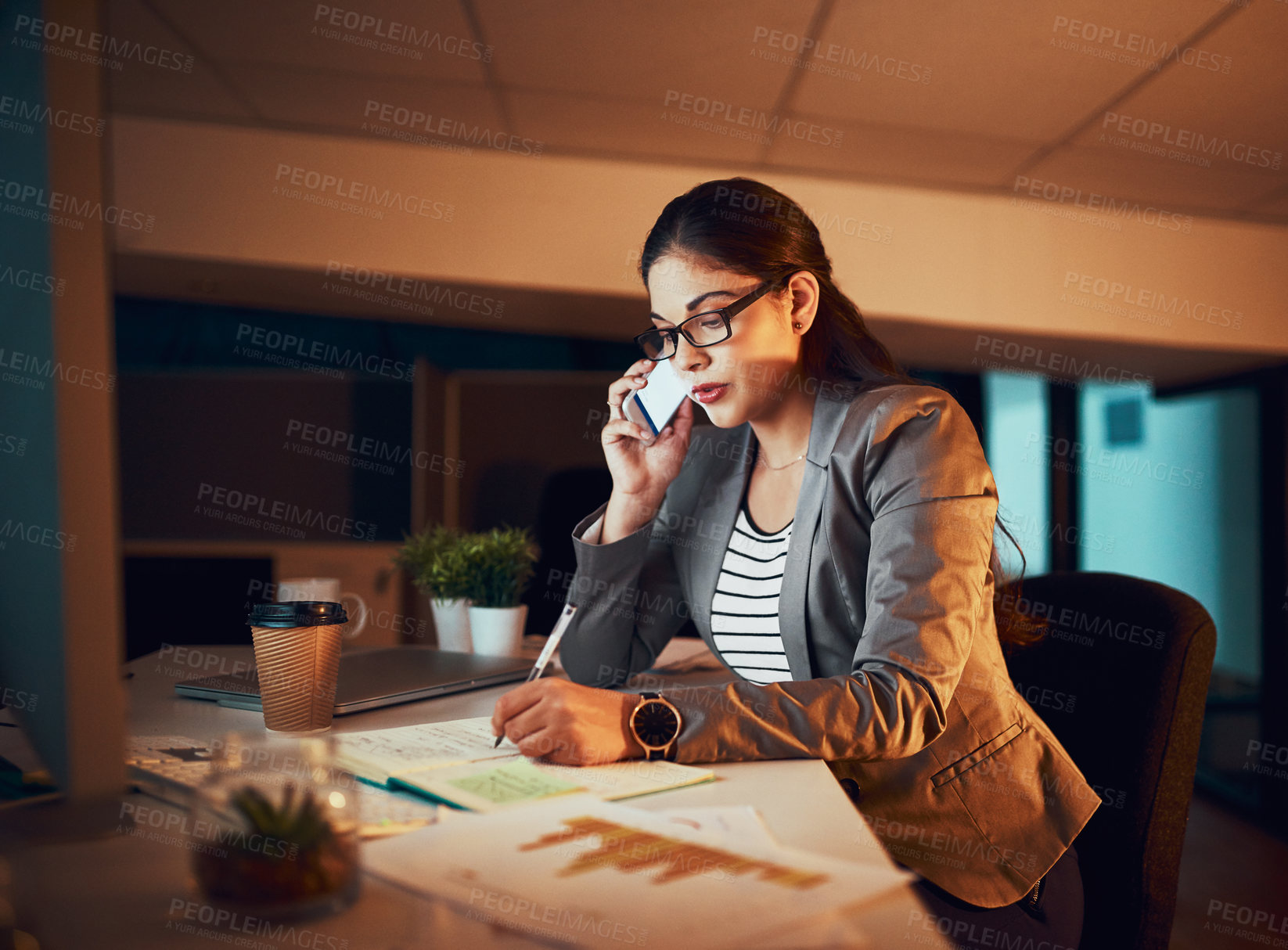 Buy stock photo Shot of a young businesswoman working late in the office