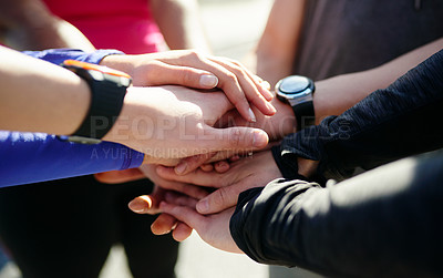 Buy stock photo Closeup of a group of unrecognizable people's hands forming a huddle outside during the day
