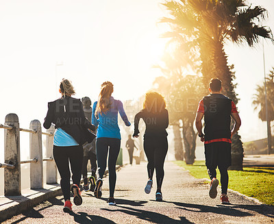 Buy stock photo Fitness, back and running with group on promenade for cardio workout or exercise together by beach. Friends, active people or team of runners in race for sprint or marathon on sidewalk by ocean coast