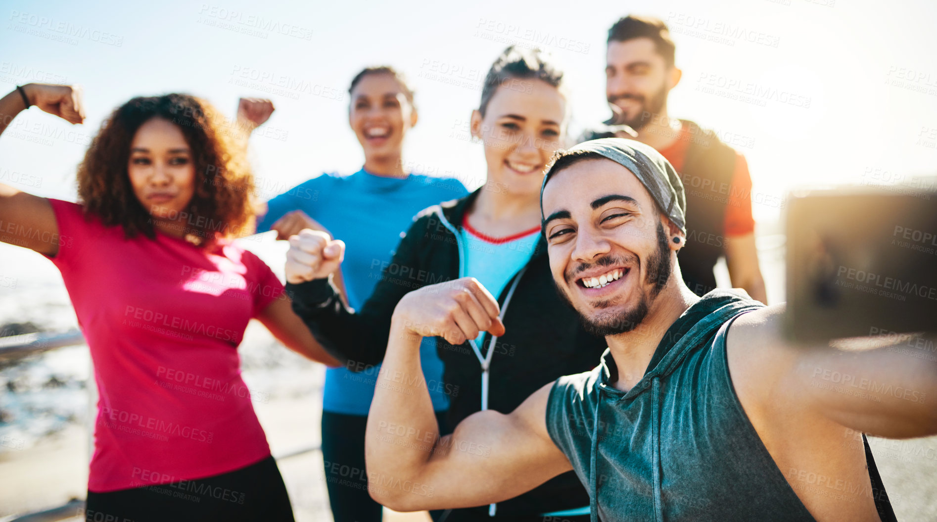 Buy stock photo Cropped shot of a fitness group taking a selfie while out for a run on the promenade