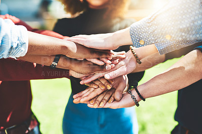 Buy stock photo Cropped shot of an unrecognizable group of college friends standing outside with their hands in a huddle