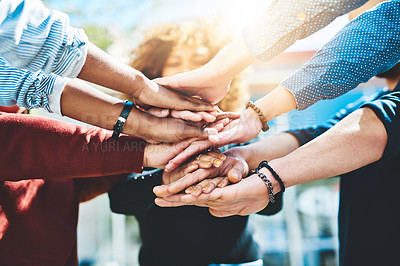 Buy stock photo Cropped shot of an unrecognizable group of college friends standing outside with their hands in a huddle