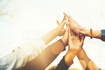 Buy stock photo Cropped shot of an unrecognizable group of college friends high fiving while standing outside