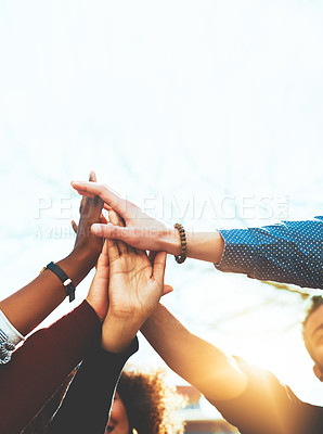 Buy stock photo Cropped shot of an unrecognizable group of college friends high fiving while standing outside