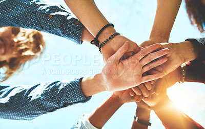 Buy stock photo High angle shot of an unrecognizable group of college friends standing outside with their hands in a huddle