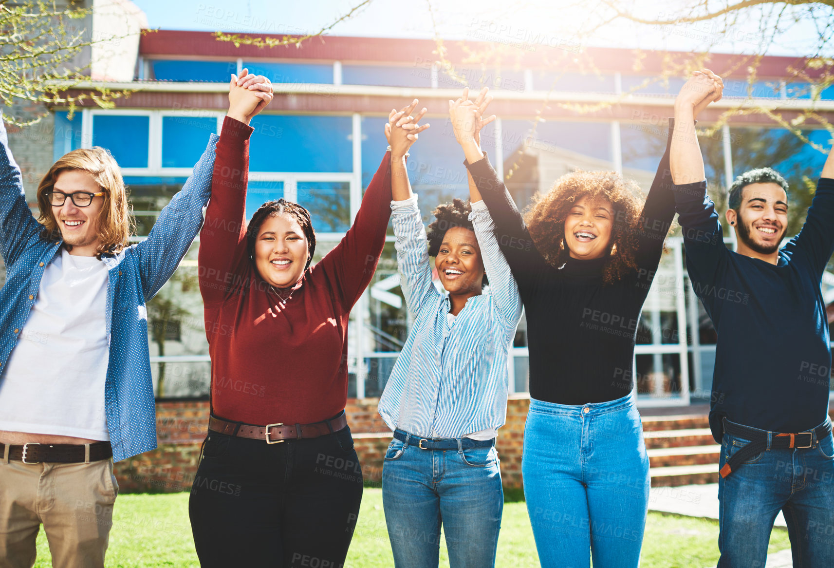 Buy stock photo Cropped portrait of a diverse group of college friends standing outside with their arms raised