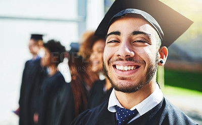 Buy stock photo Shot of a smiling university student on graduation day with classmates in the background