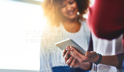Buy stock photo Shot of a group of young people using a digital tablet together