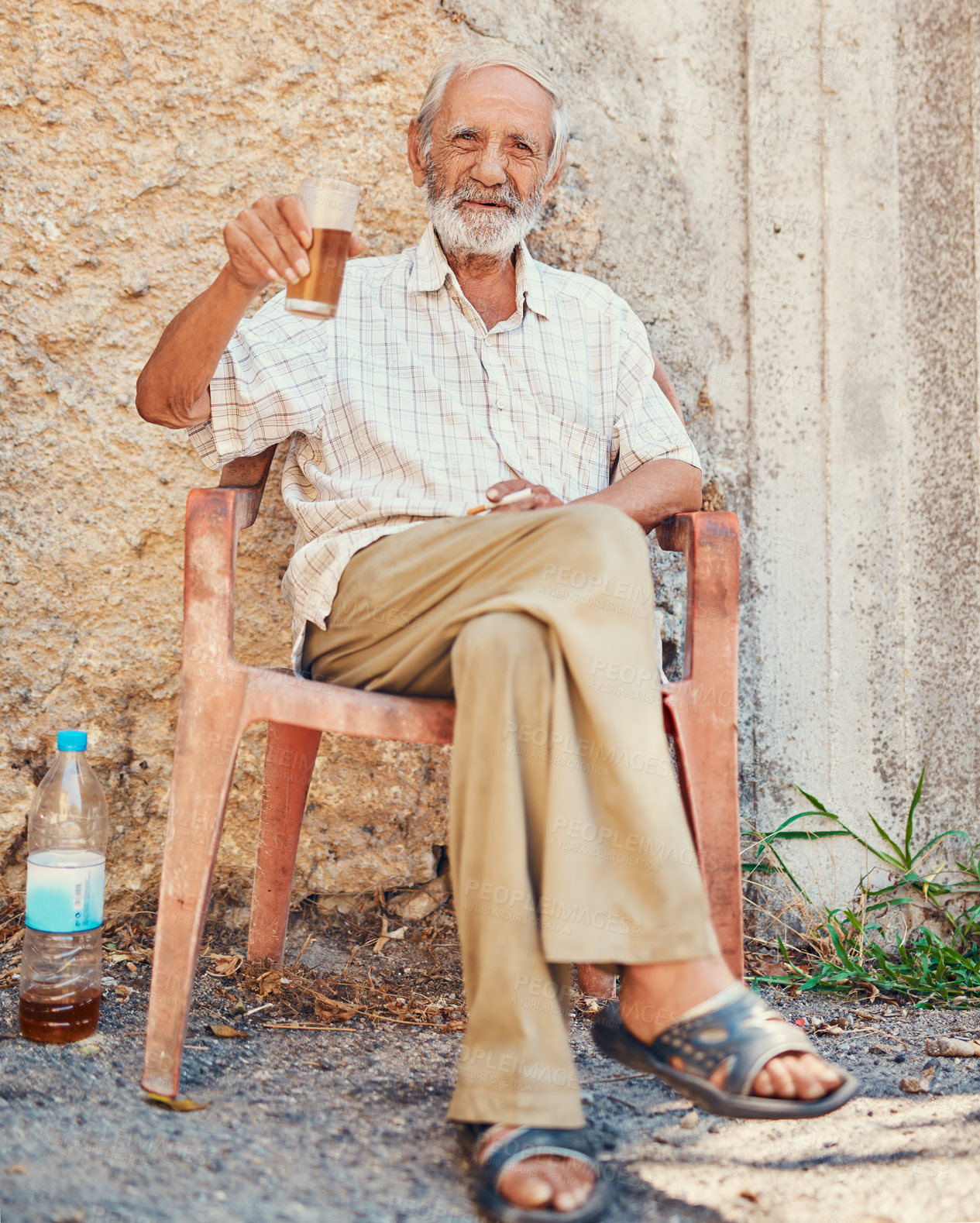 Buy stock photo Portrait, senior man and drinking beer in retirement on front porch, ancient architecture or wall. Pensioner, male person and comfort in old age with alcohol beverage, relax and elderly care in Italy