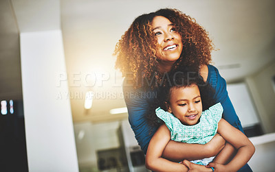 Buy stock photo Shot of a young mother and her daughter spending quality time together at home
