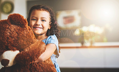 Buy stock photo Portrait of a little girl holding her teddy bear at home