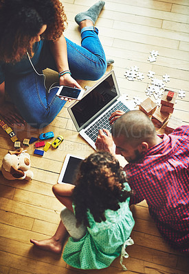 Buy stock photo Shot of a family of three using modern technology at home