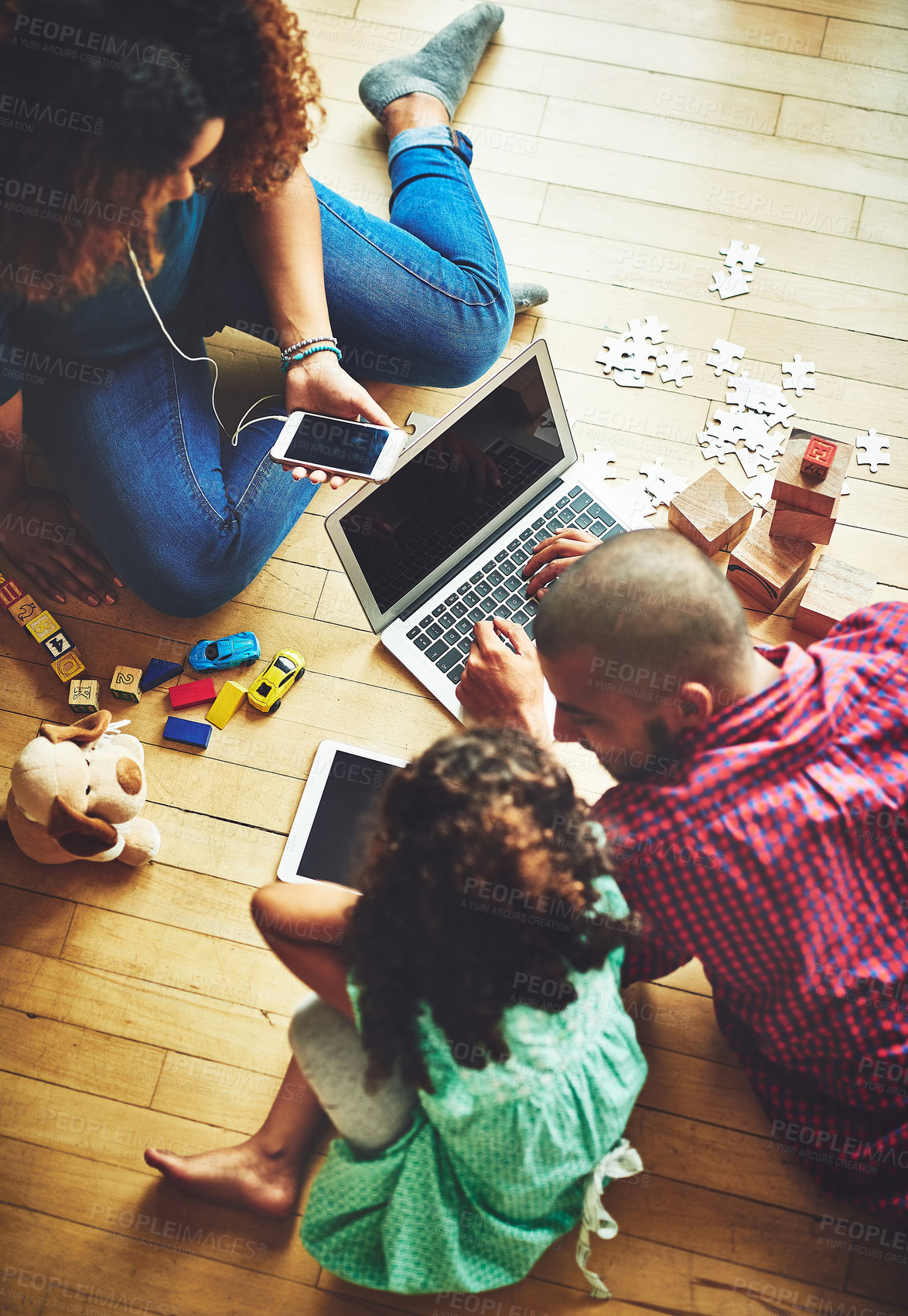 Buy stock photo Shot of a family of three using modern technology at home