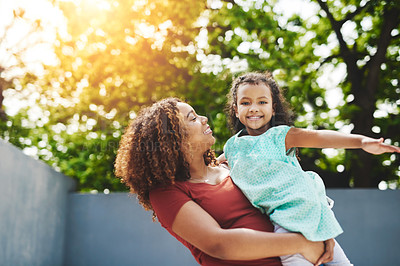 Buy stock photo Shot of a happy little girl and her mother having fun in their backyard