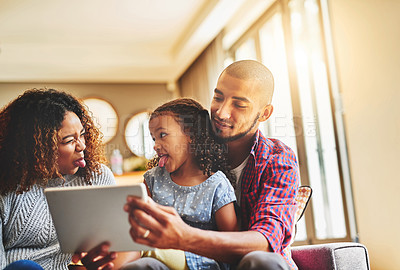 Buy stock photo Tablet, happy family and funny selfie in living room together for social media, bonding and relax. Kid, mother and father on digital technology for picture, memory and photo with tongue out in home