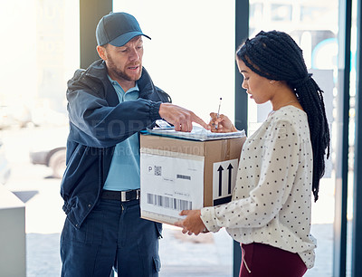 Buy stock photo Cropped shot of a handsome delivery man getting a signature from a female customer for her order