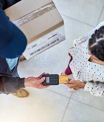 Buy stock photo High angle shot of an unrecognizable delivery man receiving payment from a female customer for her order