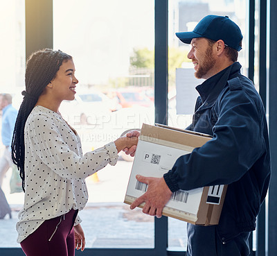 Buy stock photo Cropped shot of a handsome delivery man shaking hands with a female customer