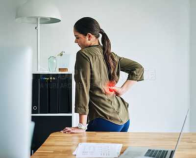 Buy stock photo Shot of a young businesswoman suffering with back pain in an office
