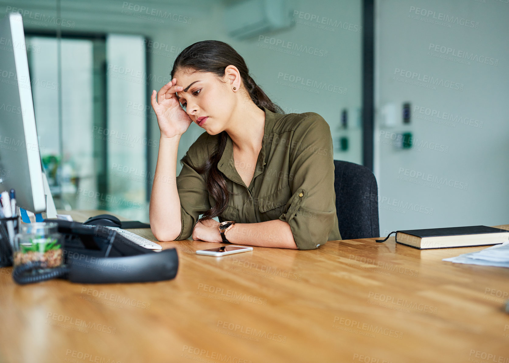 Buy stock photo Shot of a young businesswoman suffering with a headache in an office