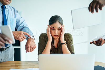 Buy stock photo Shot of a stressed out businesswoman surrounded by colleagues needing help in an office