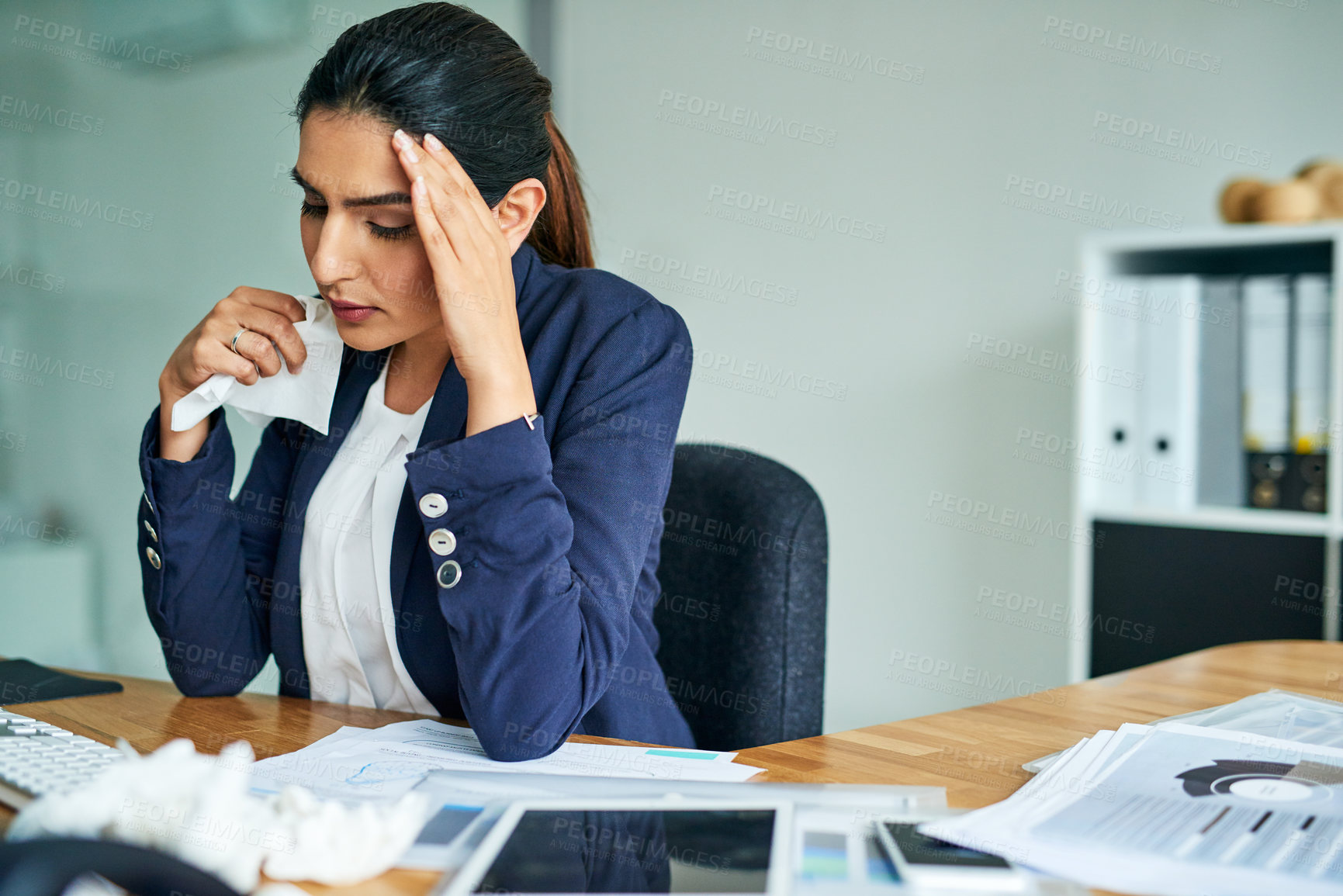 Buy stock photo Shot of a young businesswoman suffering with allergies at work