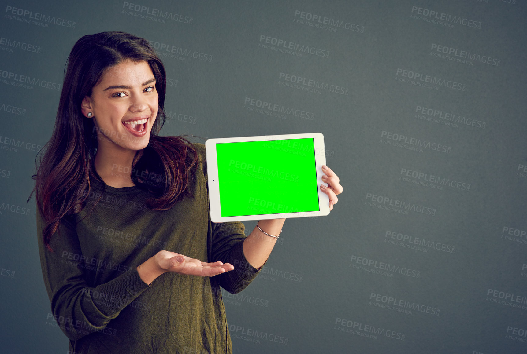 Buy stock photo Girl, tablet and portrait in studio with green screen, mock up space and promo by dark background. Person, woman and model with digital touchscreen, chromakey and blank ux for application in Mexico