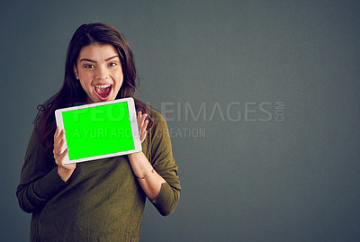 Buy stock photo Girl, tablet and excited in studio with green screen, mock up space and portrait by dark background. Person, woman and model with touchscreen for surprise, chromakey and wow for deal on app in Mexico