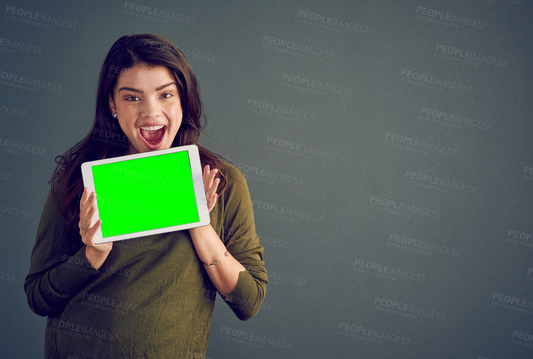 Buy stock photo Girl, tablet and excited in studio with green screen, mock up space and portrait by dark background. Person, woman and model with touchscreen for surprise, chromakey and wow for deal on app in Mexico