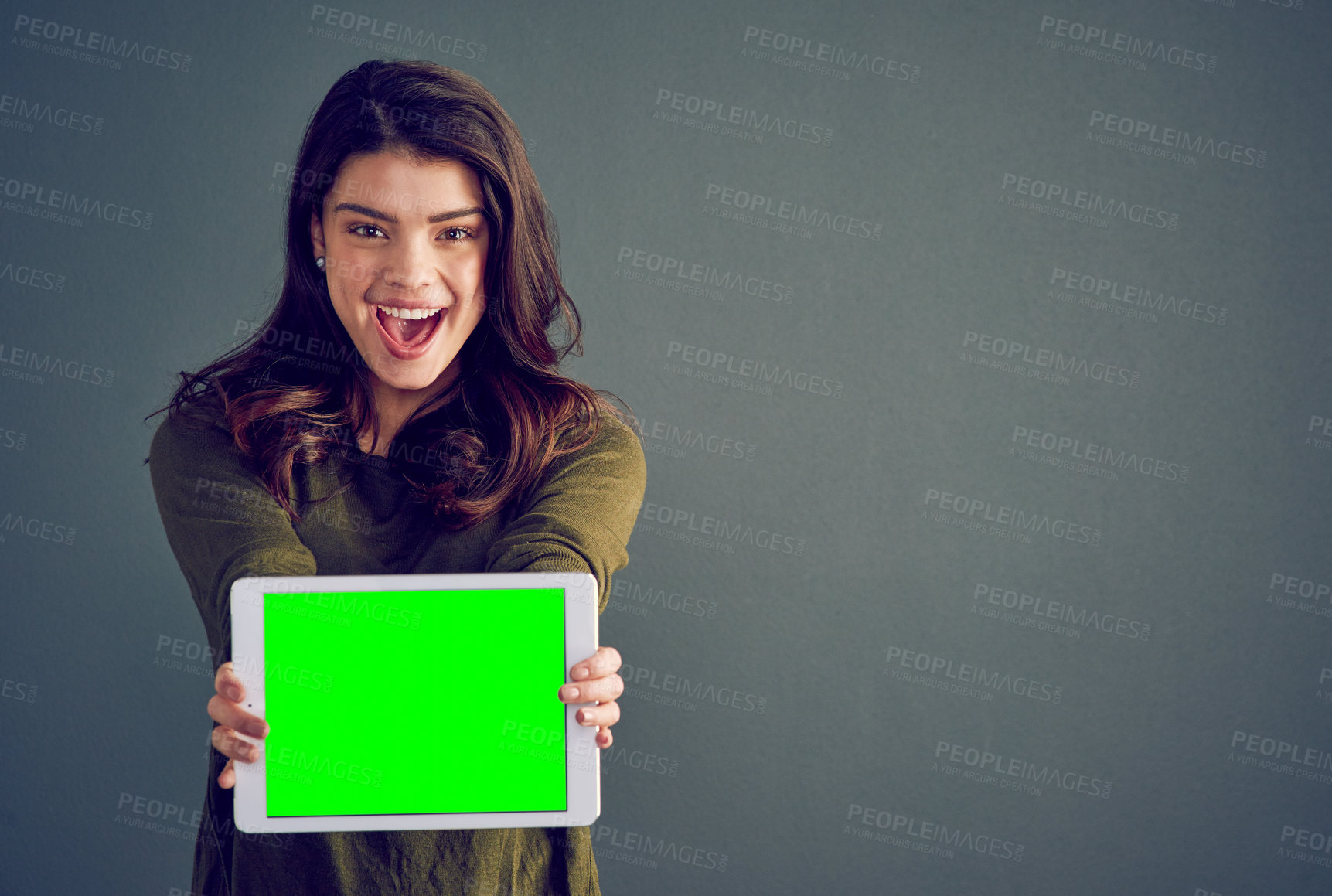 Buy stock photo Girl, tablet and happy in studio with green screen, mock up space and portrait by dark background. Person, woman and model with touchscreen for surprise, chromakey and wow for deal on app in Mexico