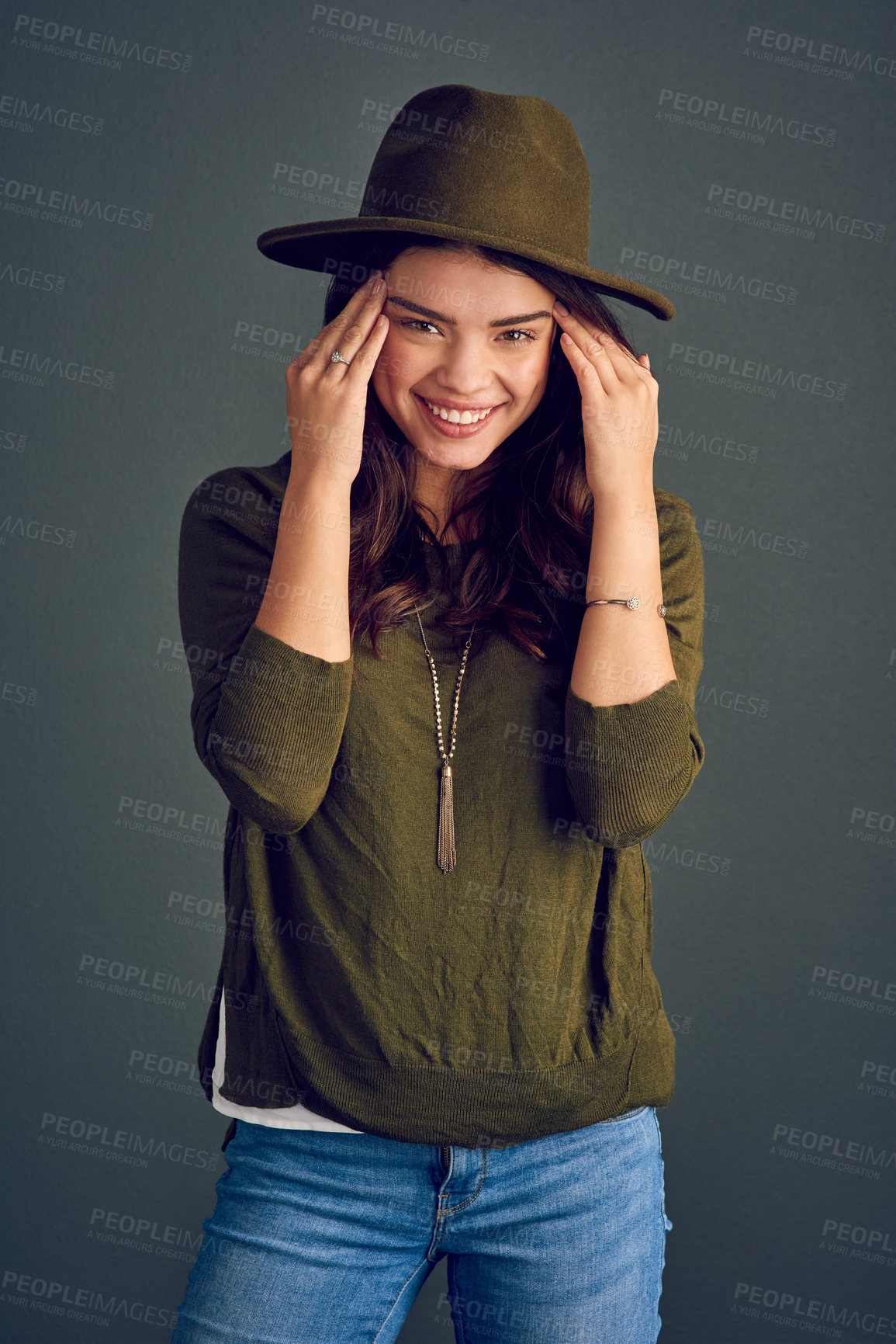 Buy stock photo Woman, portrait and smile in studio for fashion, style and cool playful attitude on gray background. Female person, face and happy facial expression for confidence, pride and trendy outfit aesthetic