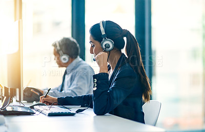 Buy stock photo Cropped shot of two customer service representatives at work in their office