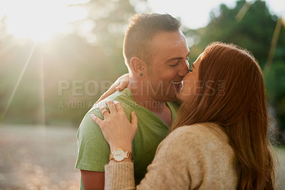 Buy stock photo Shot of an affectionate young couple spending a day outdoors