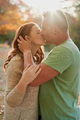 Buy stock photo Shot of an affectionate young couple spending a day outdoors