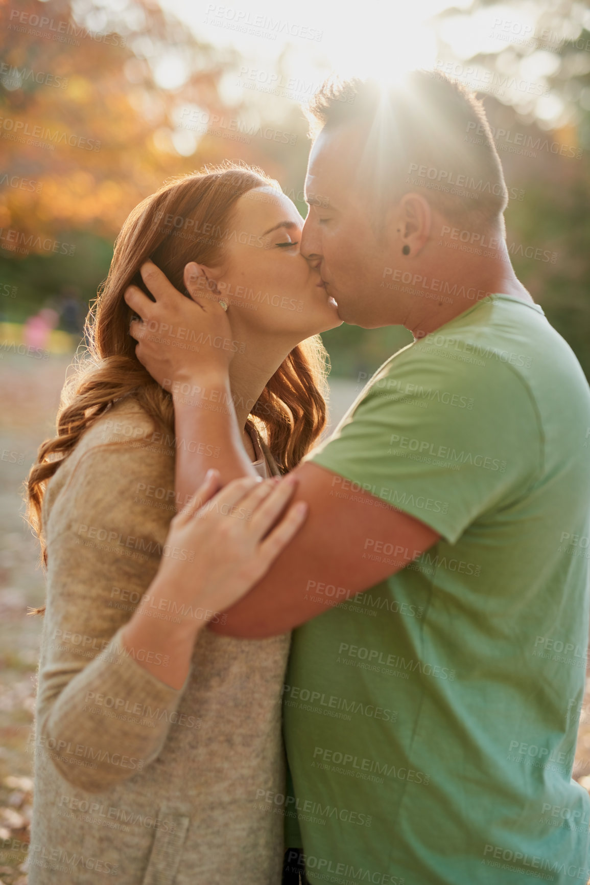 Buy stock photo Outdoor, couple and affection with kiss for relationship, connection and bonding together on date. Happy people, woman and man with hug for admiration, love and commitment with security in Canada