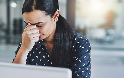 Buy stock photo Cropped shot of an attractive young businesswoman experiencing a headache in her office