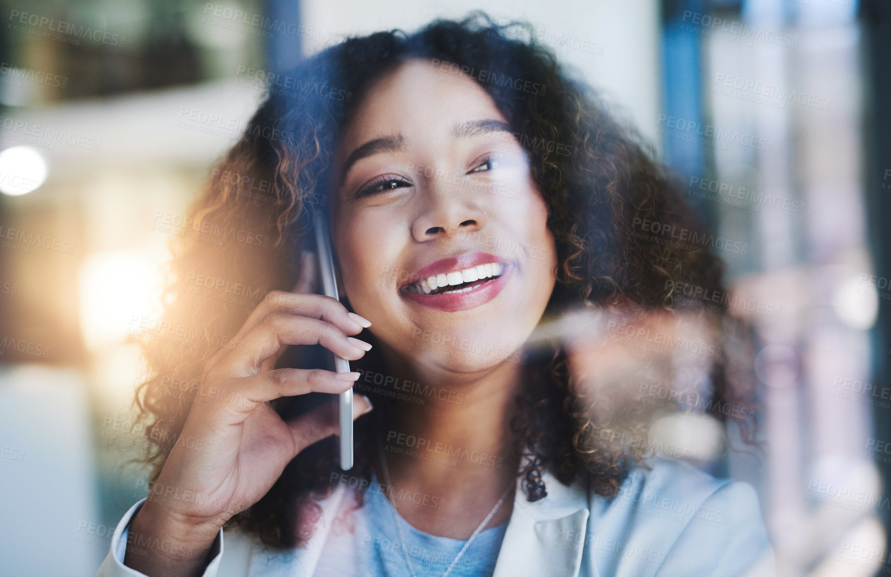 Buy stock photo Shot of a young businesswoman talking on a cellphone in an office
