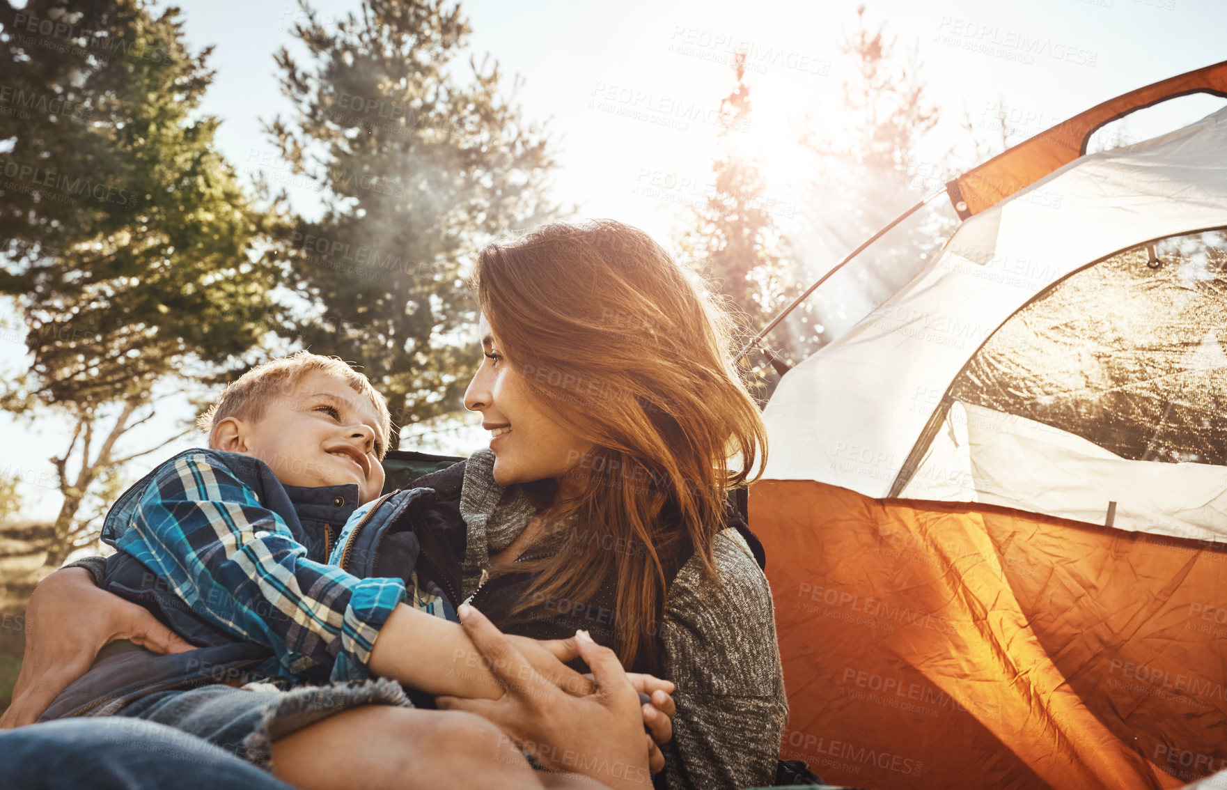 Buy stock photo Shot of a young beautiful mother and her son camping in the forest