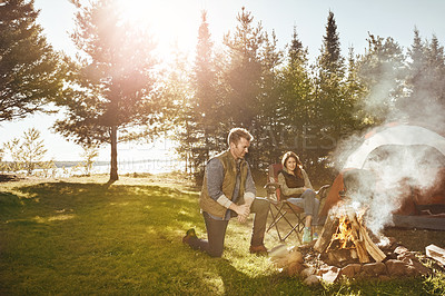 Buy stock photo Shot of a young married couple camping in the forest