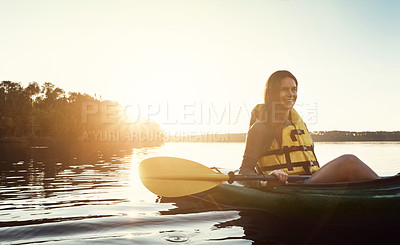 Buy stock photo Happy woman, canoeing and relax with paddle in sunset for travel, hobby or outdoor journey by ocean water, lake or nature. Female person, rowing boat and smile for sunshine adventure, kayak or sea