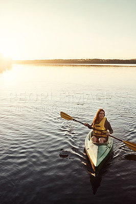 Buy stock photo Happy woman, kayaking and ocean with paddle in sunset for travel, hobby or outdoor holiday in water, lake or nature. Young female person rowing boat or smile on sunshine adventure or canoeing at sea