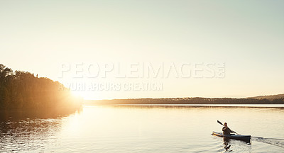 Buy stock photo Shot of a man kayaking on a lake outdoors